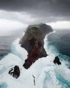 A large body of water next to a cliff